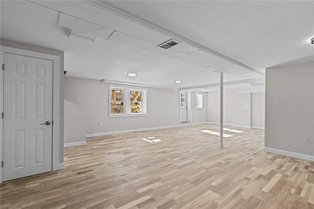 basement with light hardwood / wood-style floors