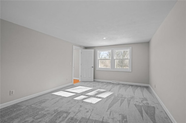 spare room featuring light colored carpet