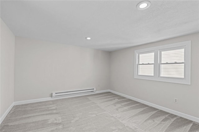 unfurnished room with light carpet and baseboard heating