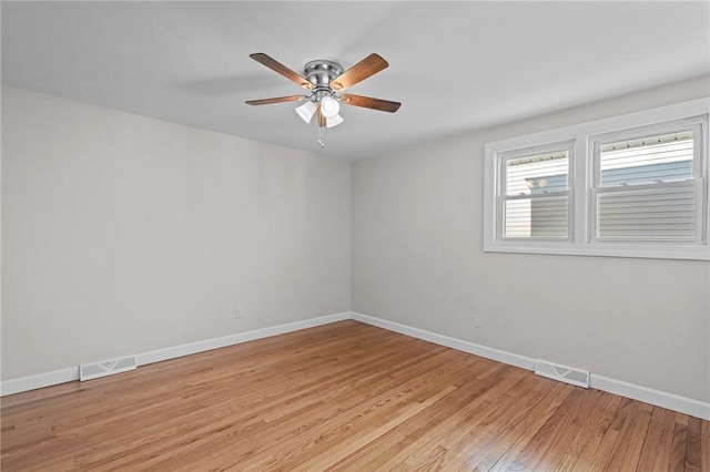 spare room with light hardwood / wood-style flooring and ceiling fan