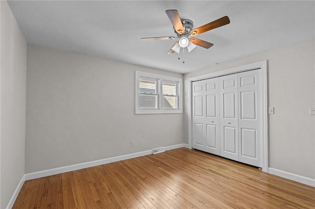 unfurnished bedroom with a closet, ceiling fan, and light wood-type flooring