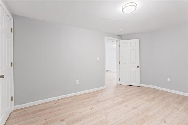 spare room featuring light hardwood / wood-style flooring