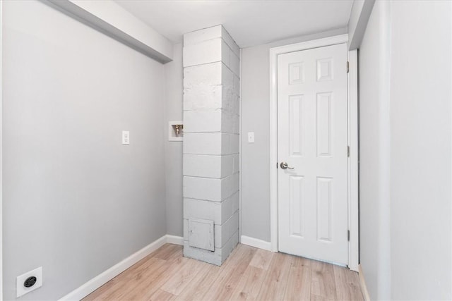 washroom with hookup for a washing machine, electric dryer hookup, and light hardwood / wood-style flooring