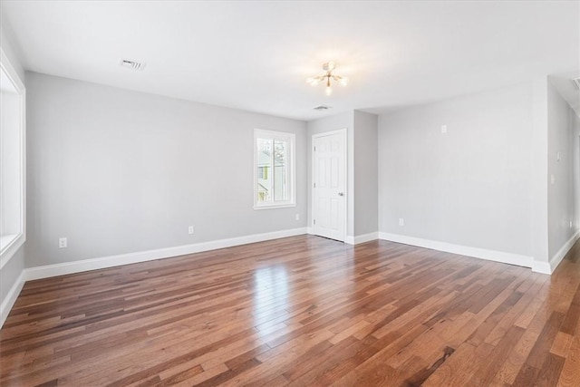 spare room with wood-type flooring