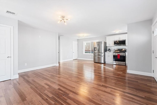 unfurnished living room with hardwood / wood-style flooring