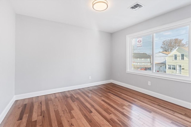 spare room featuring wood-type flooring