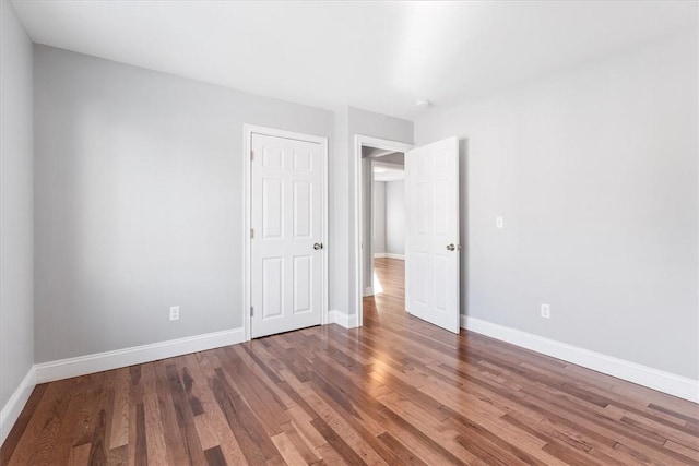 unfurnished bedroom with hardwood / wood-style floors