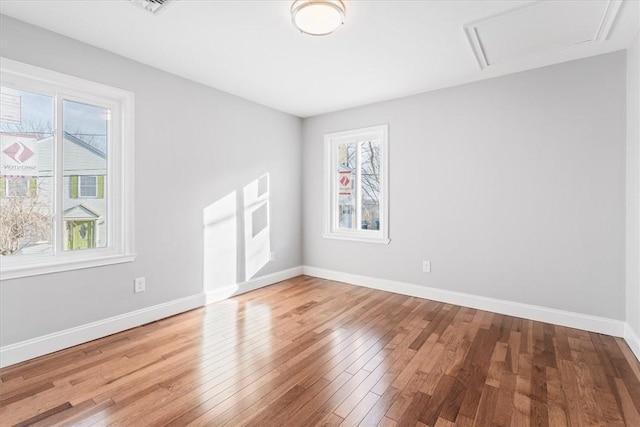 spare room with wood-type flooring