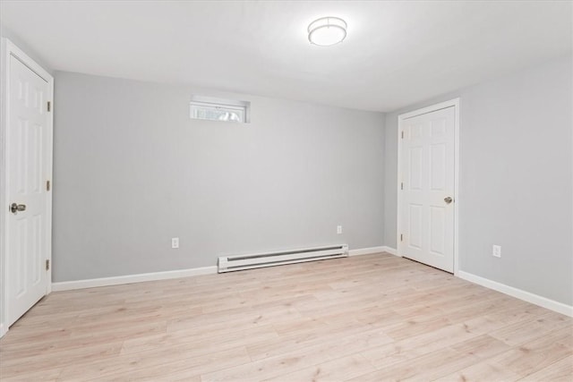 interior space featuring light hardwood / wood-style flooring and a baseboard heating unit