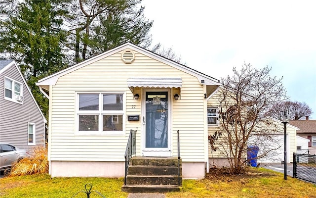 bungalow-style house featuring a front lawn