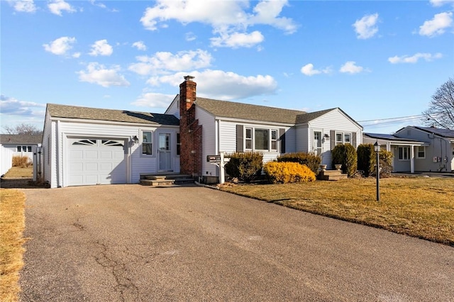 single story home featuring a garage and a front yard