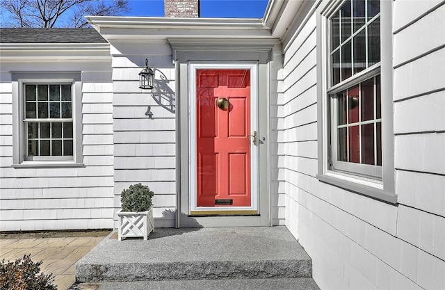 entrance to property featuring a chimney