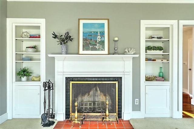 interior space featuring built in shelves and a tile fireplace