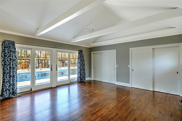 unfurnished bedroom with wood finished floors, vaulted ceiling with beams, access to exterior, an inviting chandelier, and two closets