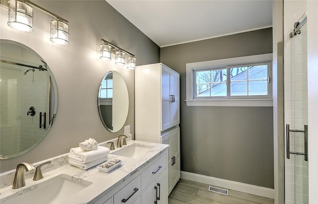 bathroom featuring a sink, visible vents, and a shower stall