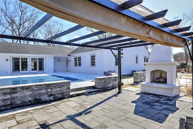 view of patio / terrace with a large fireplace and a pergola