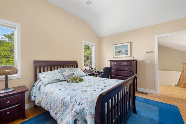 bedroom with hardwood / wood-style floors and vaulted ceiling