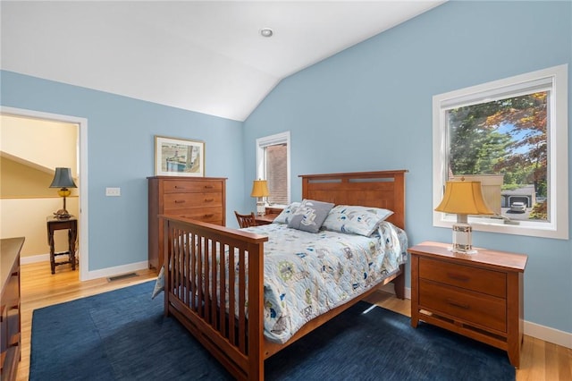 bedroom featuring lofted ceiling and hardwood / wood-style floors