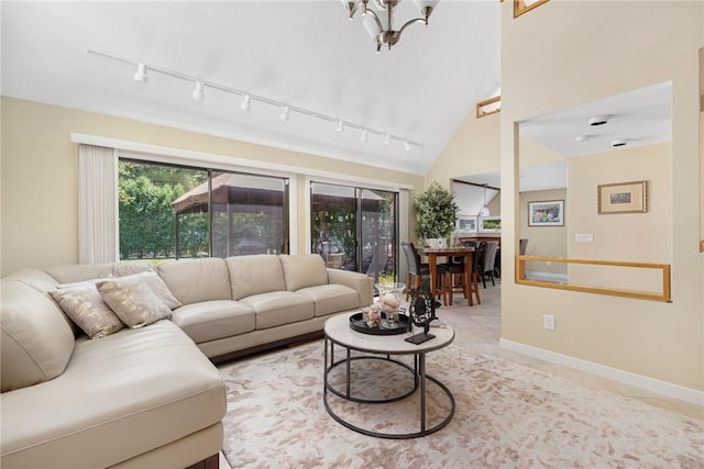 tiled living room with vaulted ceiling and an inviting chandelier