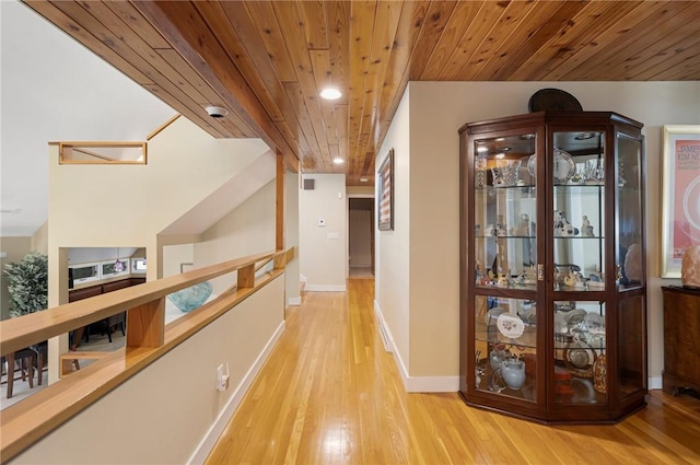 hall featuring wooden ceiling and light hardwood / wood-style floors