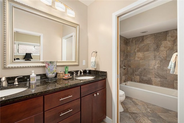 full bathroom featuring vanity, toilet, and tiled shower / bath