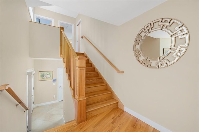 stairway with hardwood / wood-style flooring