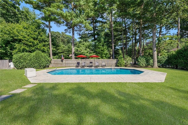 view of swimming pool featuring a yard and a patio area