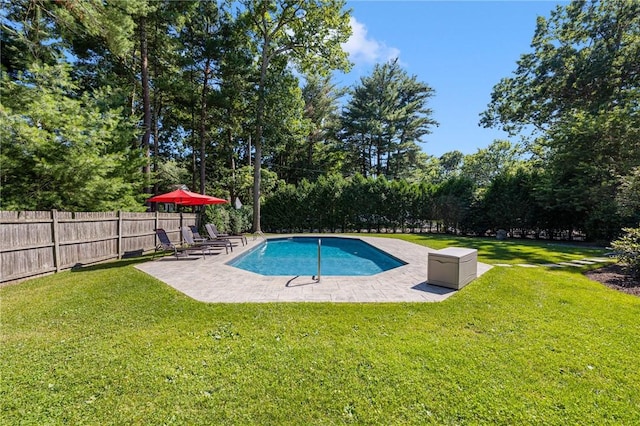 view of swimming pool with a lawn and a patio