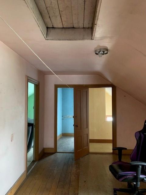 bonus room featuring hardwood / wood-style flooring and vaulted ceiling