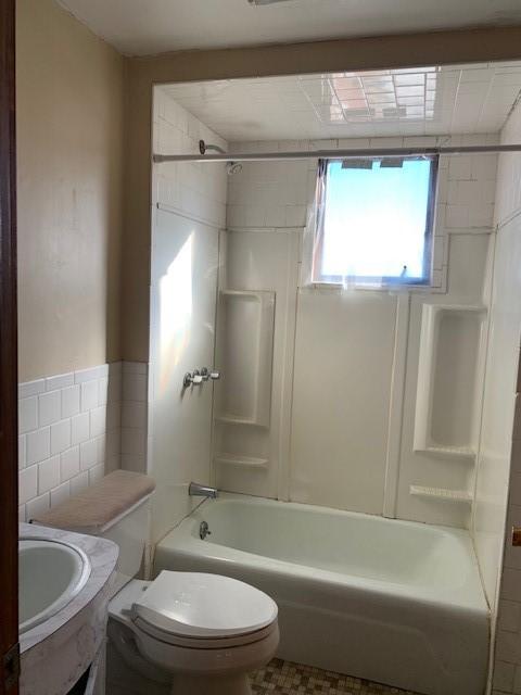 full bathroom with vanity, toilet, and tiled shower / bath combo