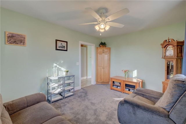 living room featuring light carpet and ceiling fan