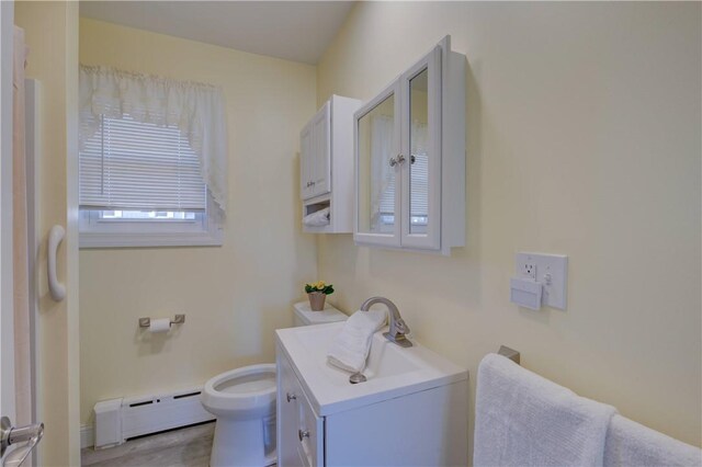 bathroom featuring a baseboard radiator, vanity, and toilet