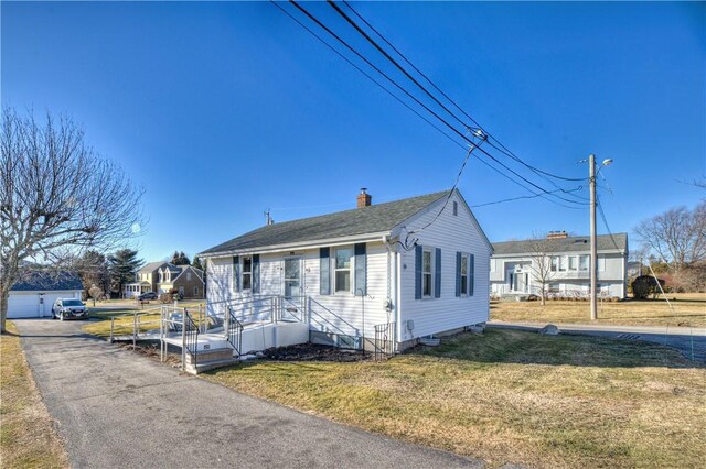 bungalow-style home with a front yard