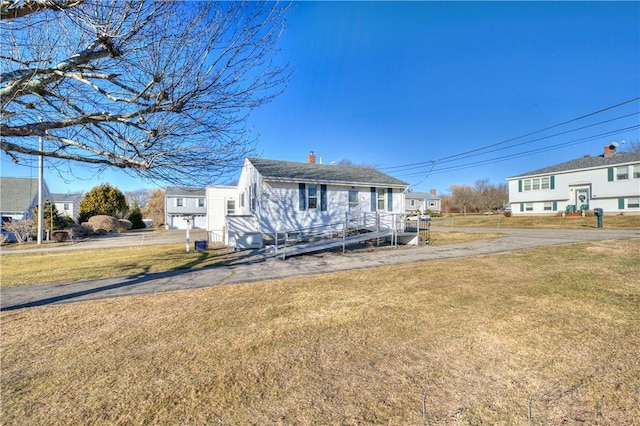 view of front of house featuring a front yard and a chimney