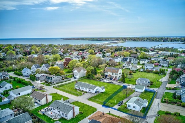 drone / aerial view with a water view and a residential view