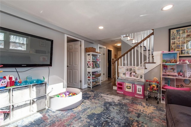 game room with dark hardwood / wood-style flooring