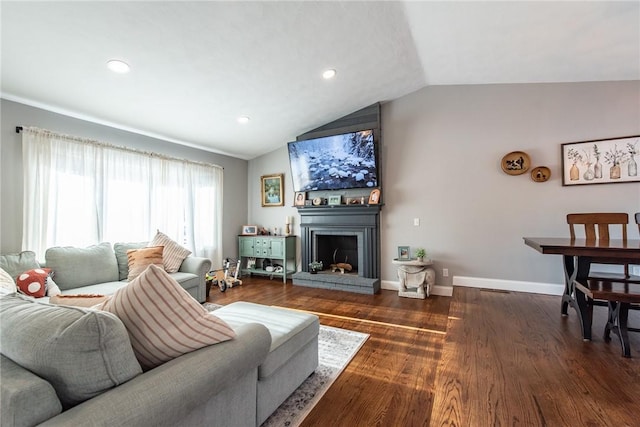 living room with dark hardwood / wood-style floors, lofted ceiling, and a fireplace