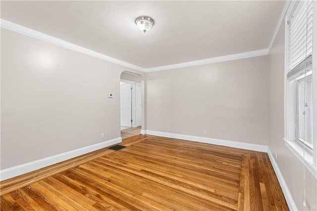 spare room featuring ornamental molding and wood-type flooring