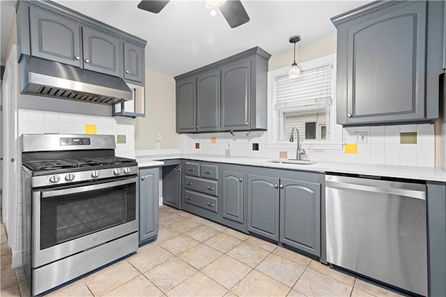 kitchen with sink, appliances with stainless steel finishes, pendant lighting, ceiling fan, and backsplash