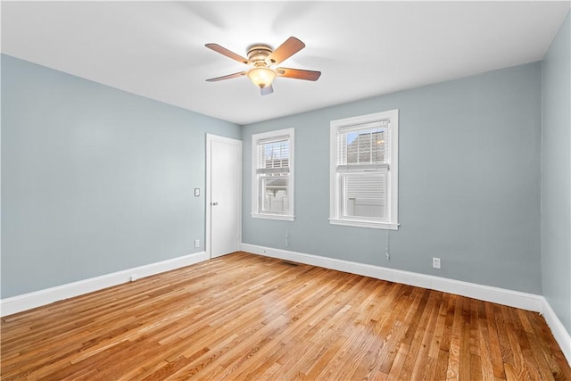 empty room featuring ceiling fan and light hardwood / wood-style floors