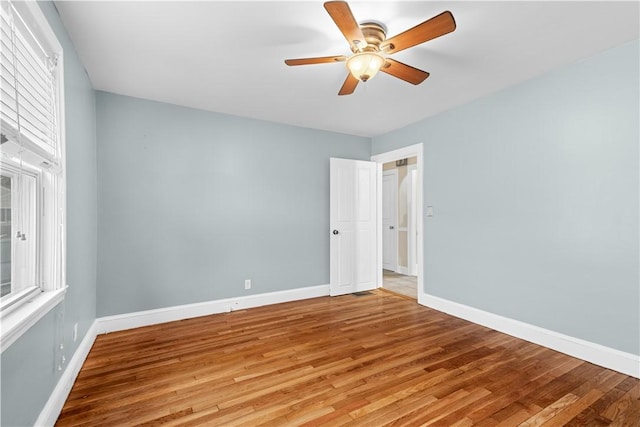 empty room with ceiling fan and light wood-type flooring