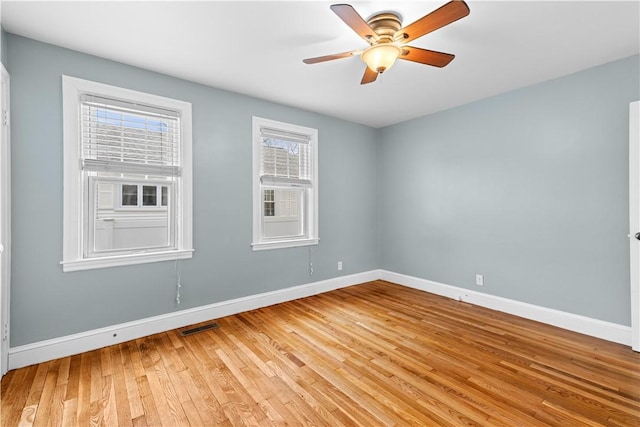 empty room featuring wood-type flooring and ceiling fan