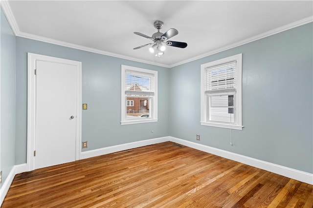 empty room with ornamental molding, ceiling fan, and light wood-type flooring