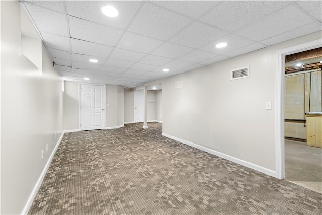 basement featuring a drop ceiling and carpet flooring