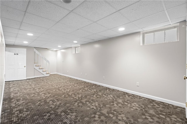 basement featuring carpet and a drop ceiling