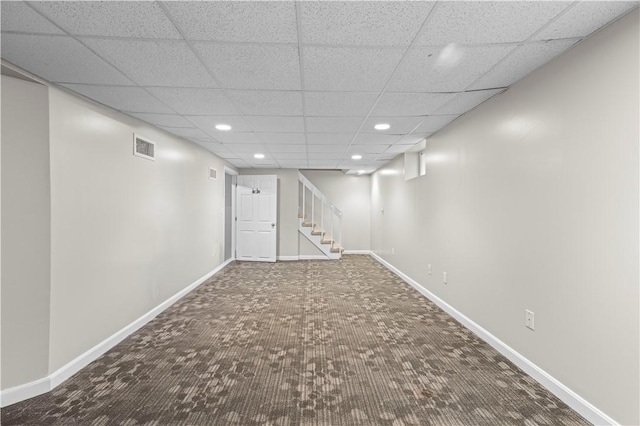 basement featuring carpet flooring and a drop ceiling