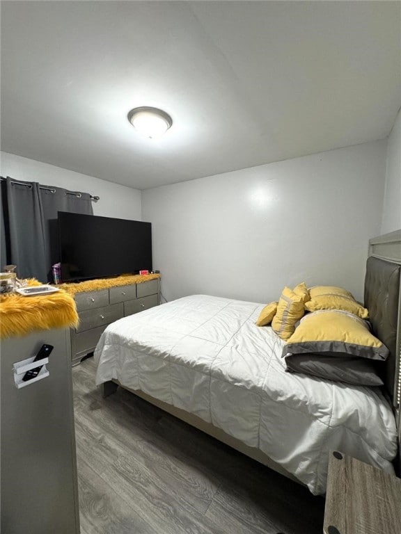 bedroom with hardwood / wood-style floors