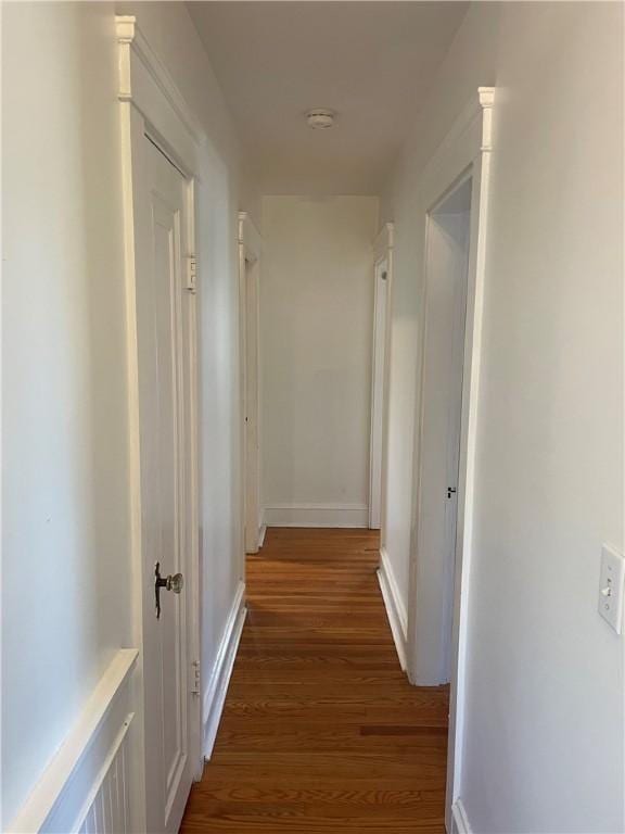 corridor with dark hardwood / wood-style floors