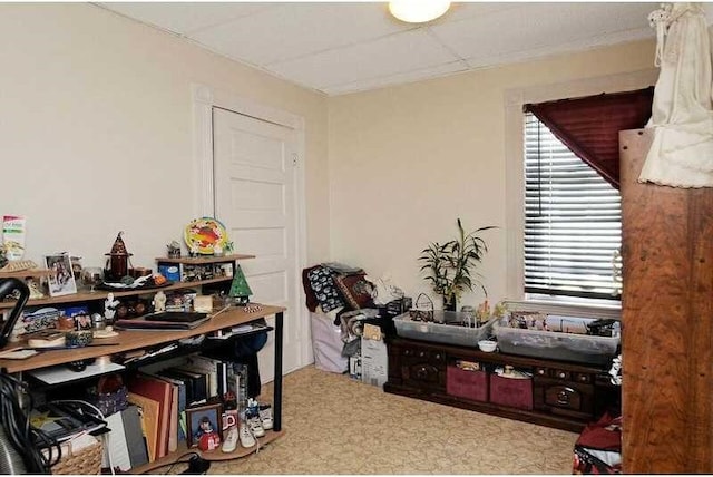 interior space with a paneled ceiling and a healthy amount of sunlight