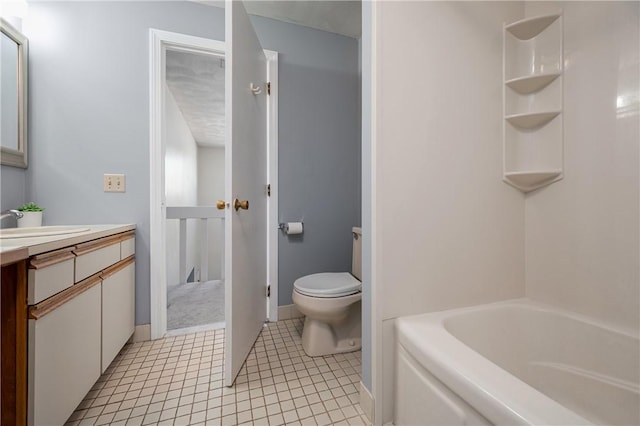 bathroom with vanity, tile patterned floors, and toilet